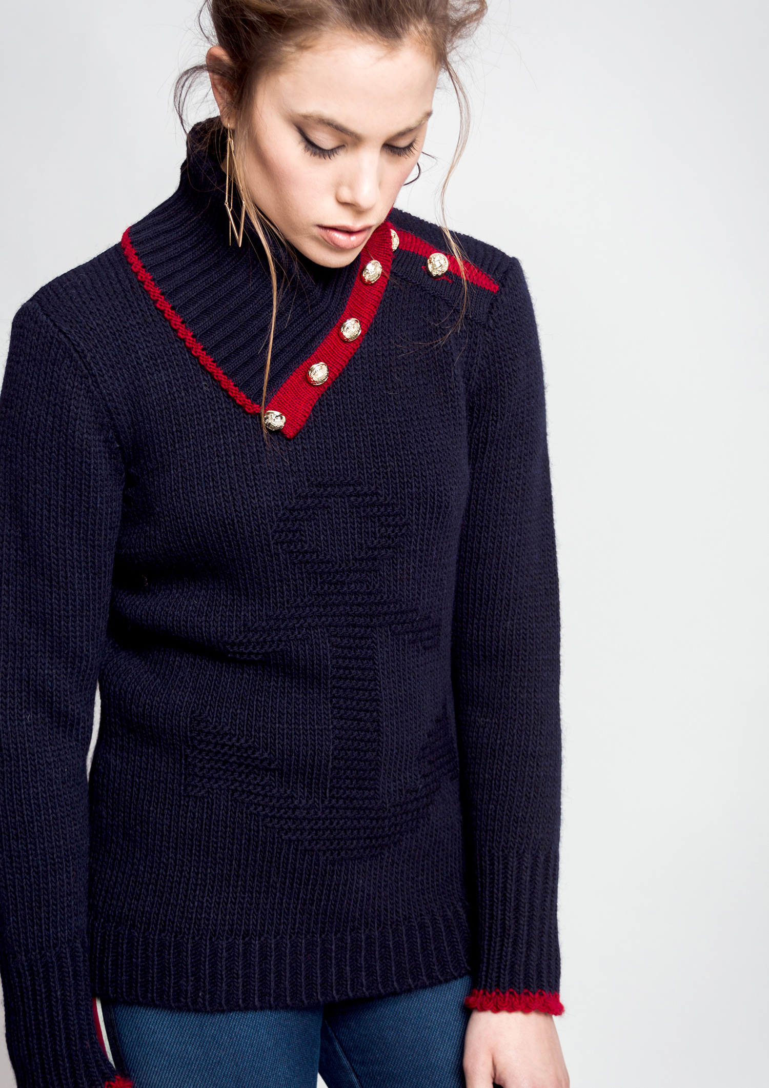 Navy jumper with buttons on neck.