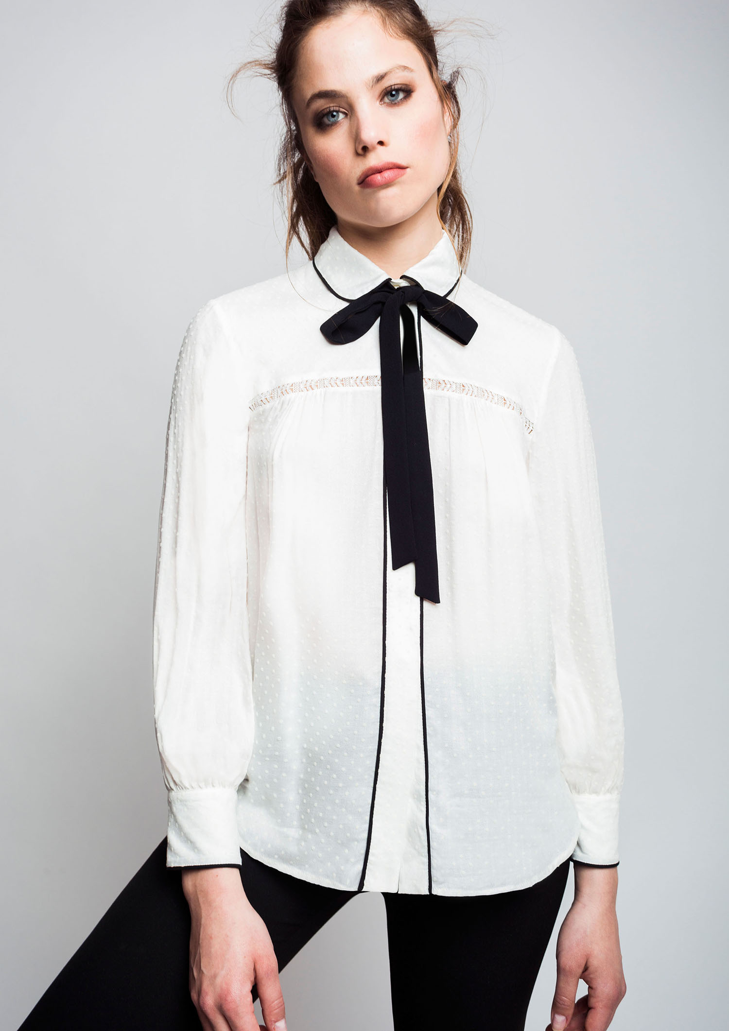 Ecru blouse with bow.