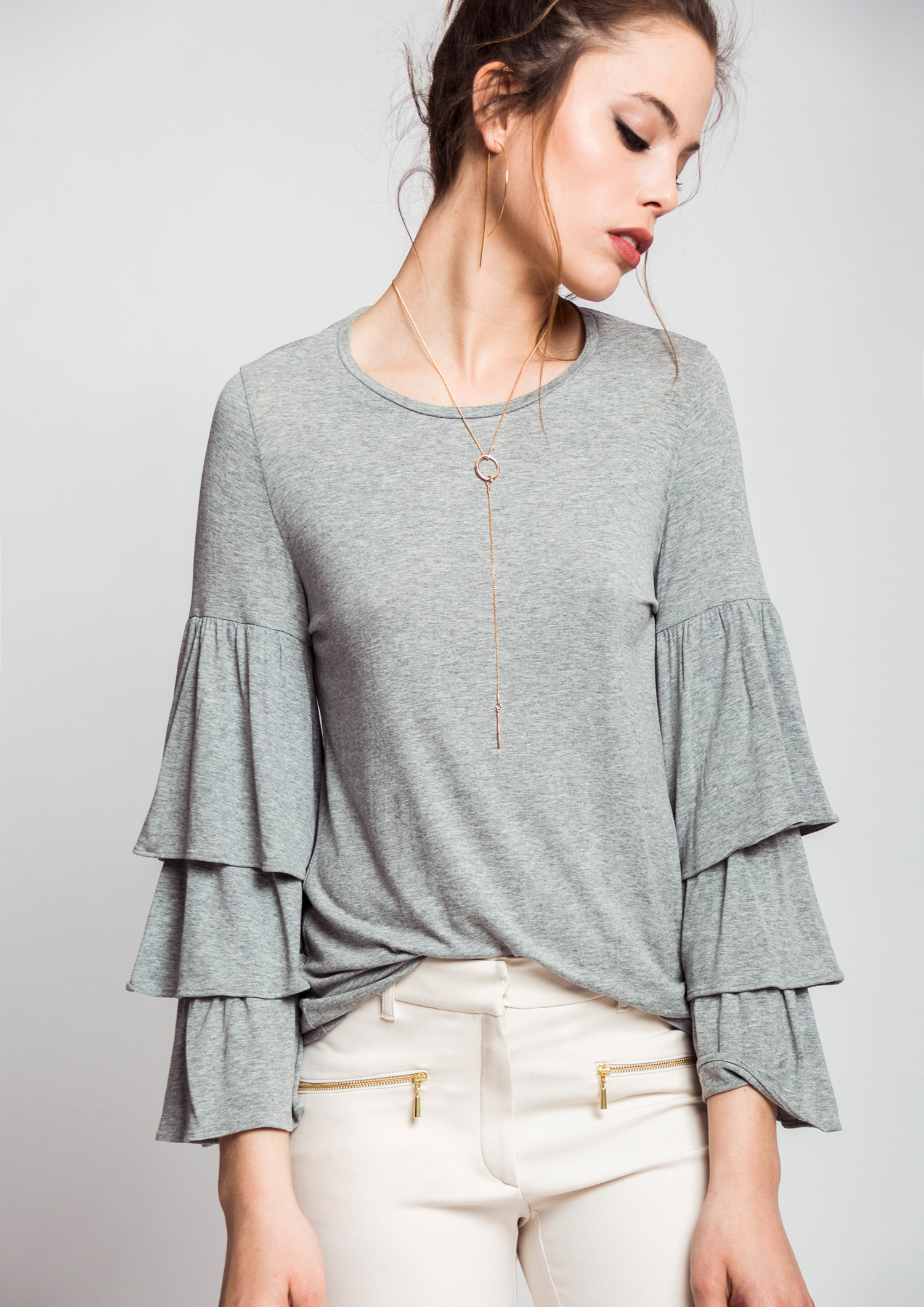 Grey T-shirt with frill sleeves.