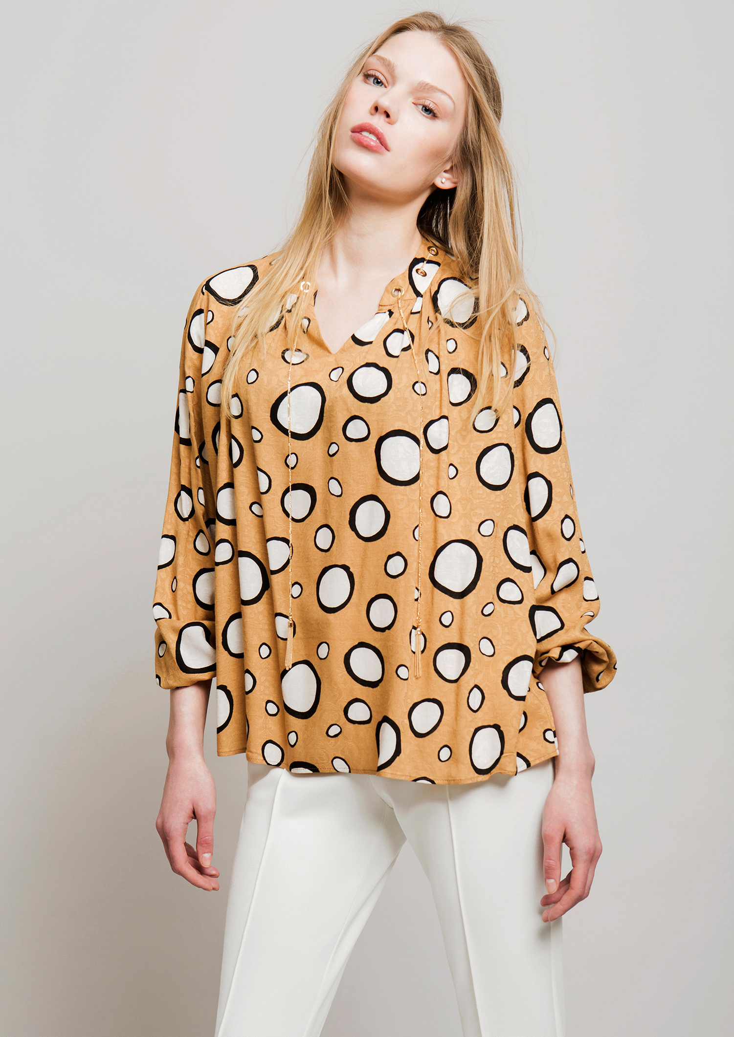 Circle print blouse.