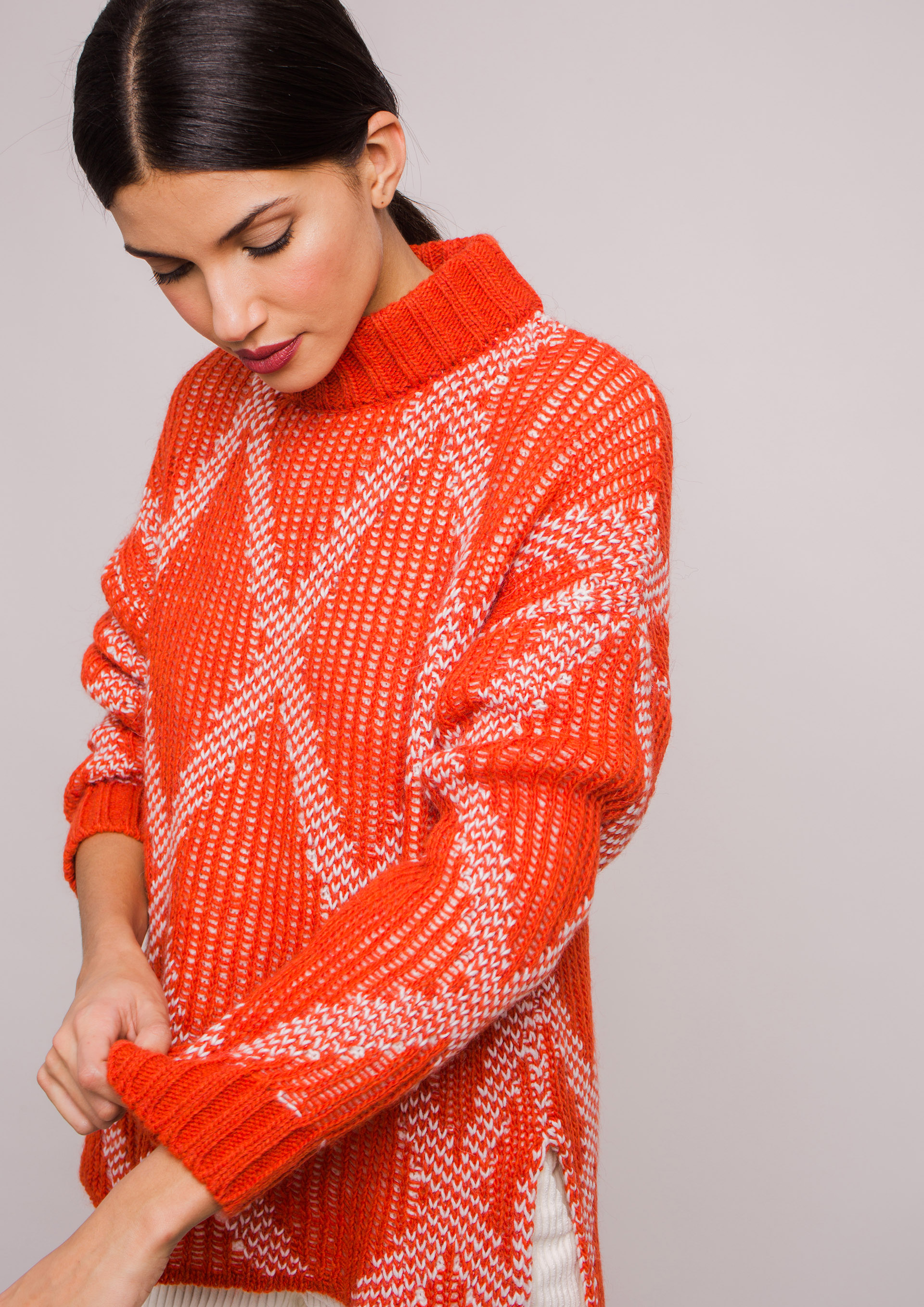 Orange knit sweater with diamond pattern.