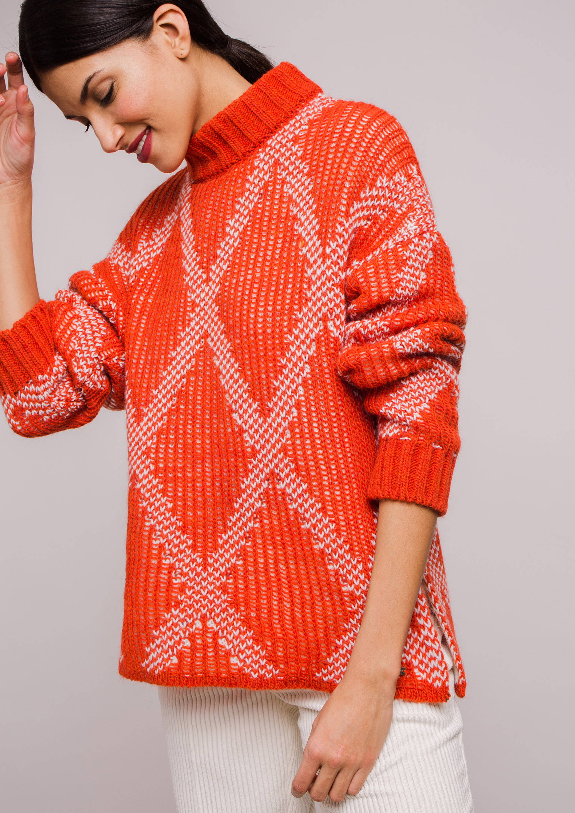 Orange knit sweater with diamond pattern.