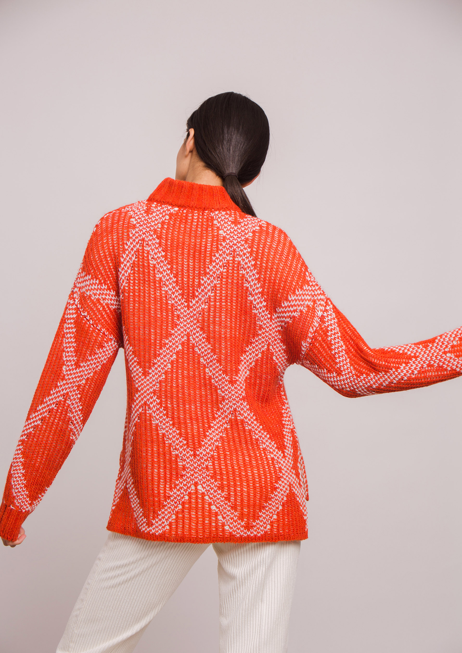 Orange knit sweater with diamond pattern.